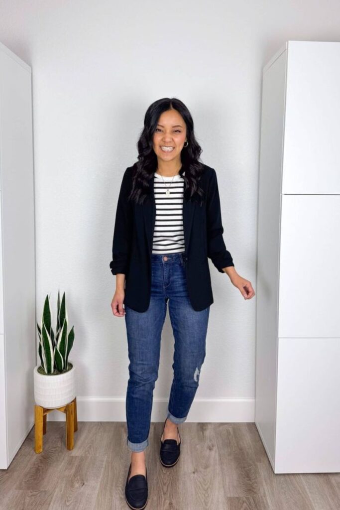 A Petite Woman Wearing A Black Blazer With a Striped Top and Ankle Pants