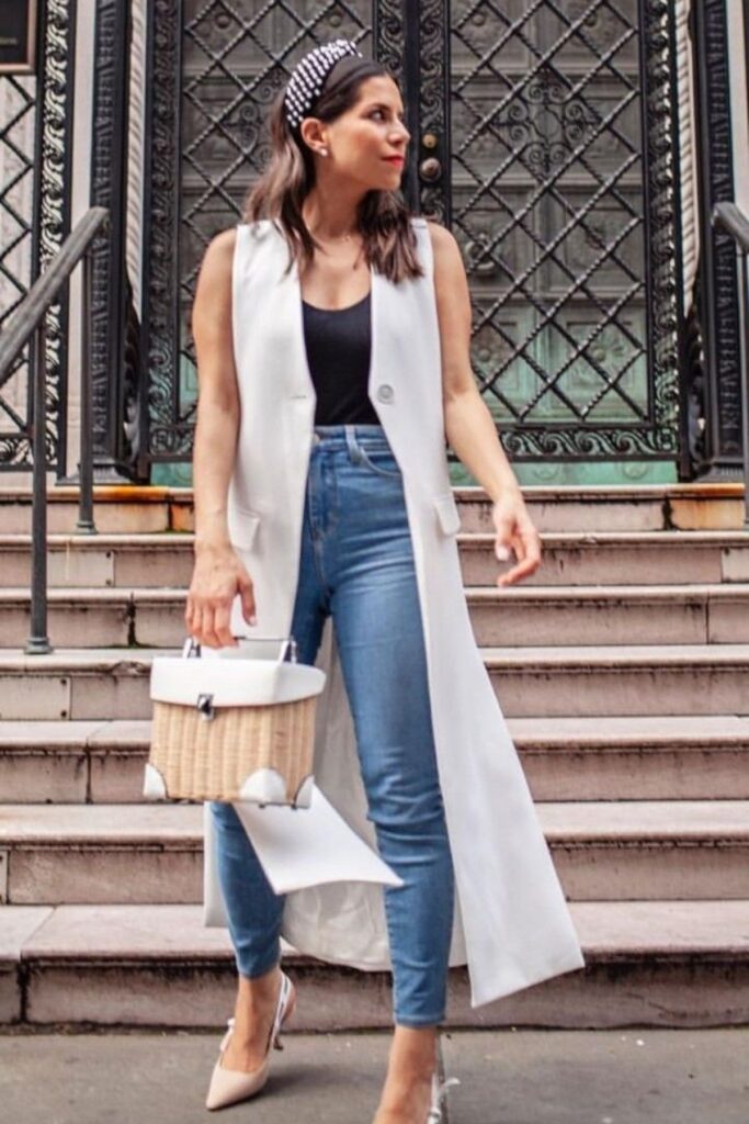 A Petite Woman Wearing A Skinny Jeans With a Longline Vest