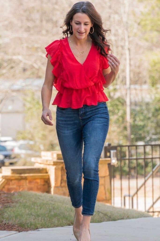 A Petite Woman Wearing A Skinny Jeans With a Statement Blouse With Ruffles