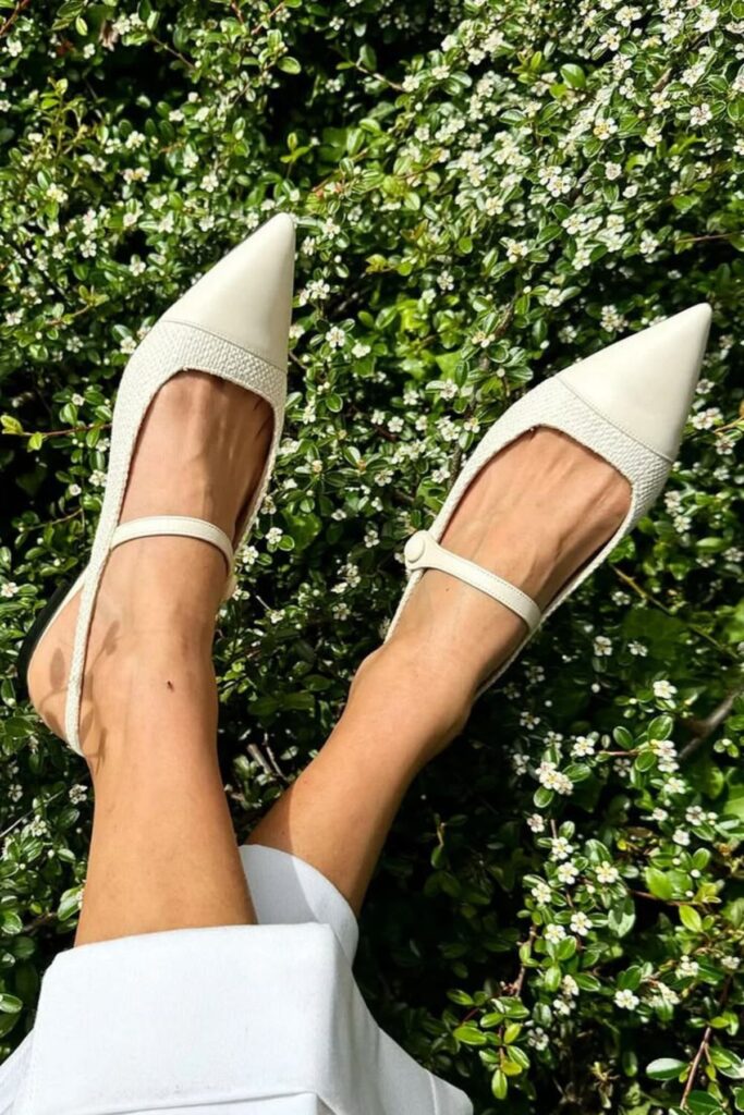 a petite woman wearing Pointed Toe Flats