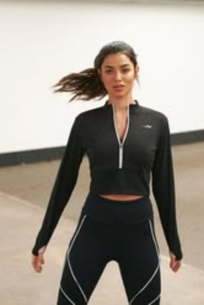 a petite woman wearing Cropped Zip-Up Athletic Top